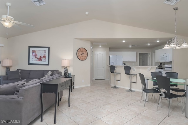 living room with light tile patterned flooring, ceiling fan with notable chandelier, and vaulted ceiling