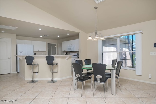 tiled dining room with vaulted ceiling and an inviting chandelier