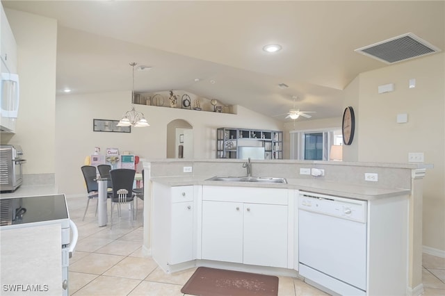 kitchen featuring lofted ceiling, dishwasher, white cabinets, and decorative light fixtures