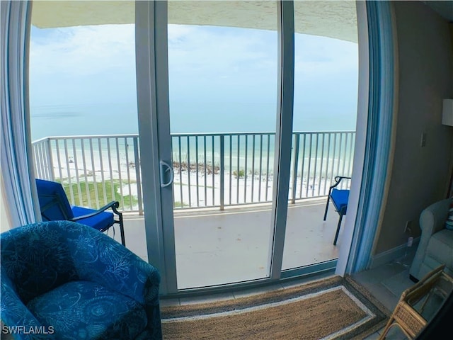 entryway featuring a water view and a beach view