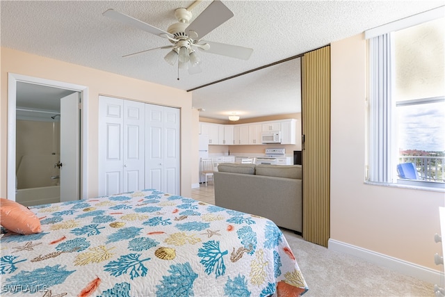 carpeted bedroom with a textured ceiling, a closet, ceiling fan, and white refrigerator