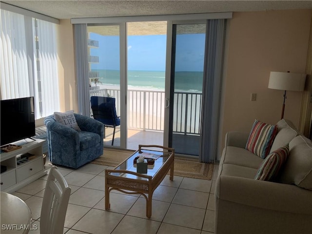 7330 Estero Blvd Unit 502, Fort Myers Beach, FL 33931 - living area with light tile patterned flooring and view of water and beach