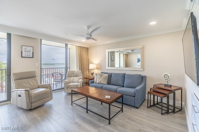 living room featuring light hardwood / wood-style floors, crown molding, a wall of windows, and ceiling fan