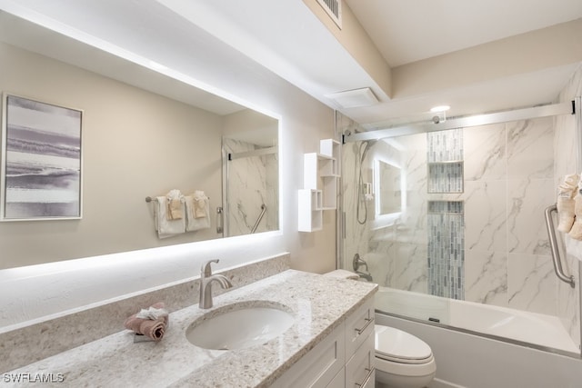 full bathroom featuring combined bath / shower with glass door, vanity, and toilet