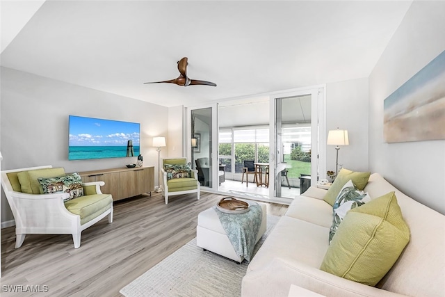 18054 San Carlos Blvd Unit 162, Fort Myers Beach, FL 33931 - living room with wood finished floors, expansive windows, and a ceiling fan