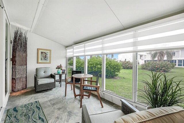 sunroom featuring vaulted ceiling