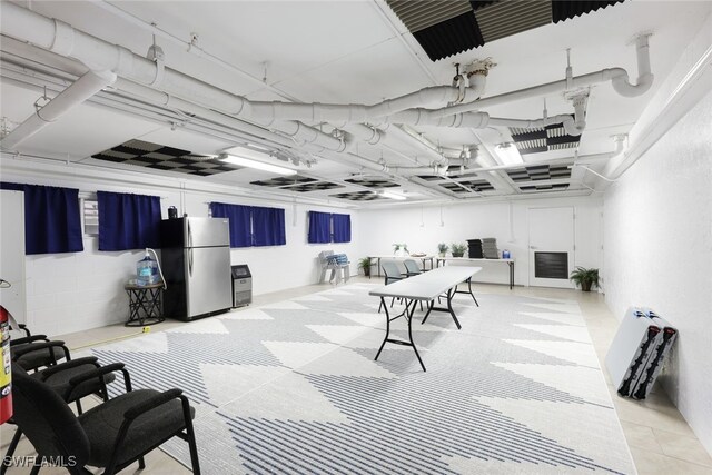 basement featuring stainless steel fridge