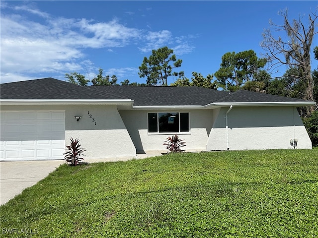 ranch-style home with a front lawn and a garage