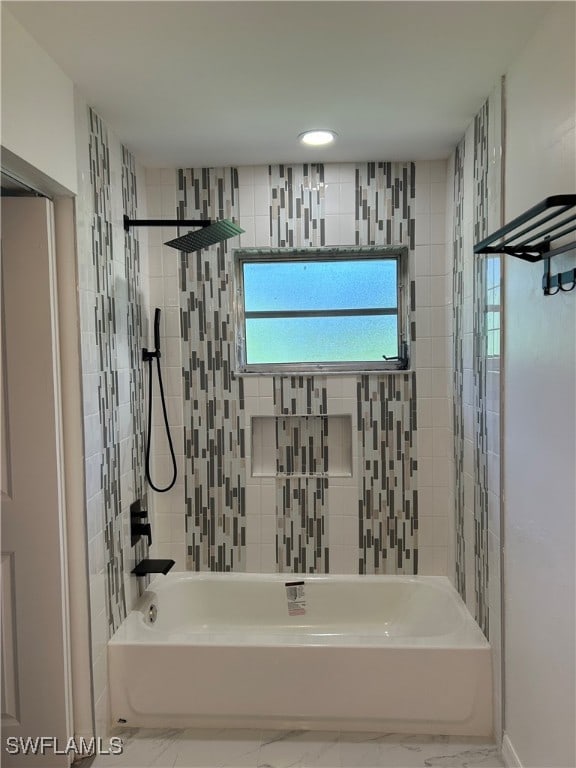 bathroom featuring tile patterned flooring and tiled shower / bath combo