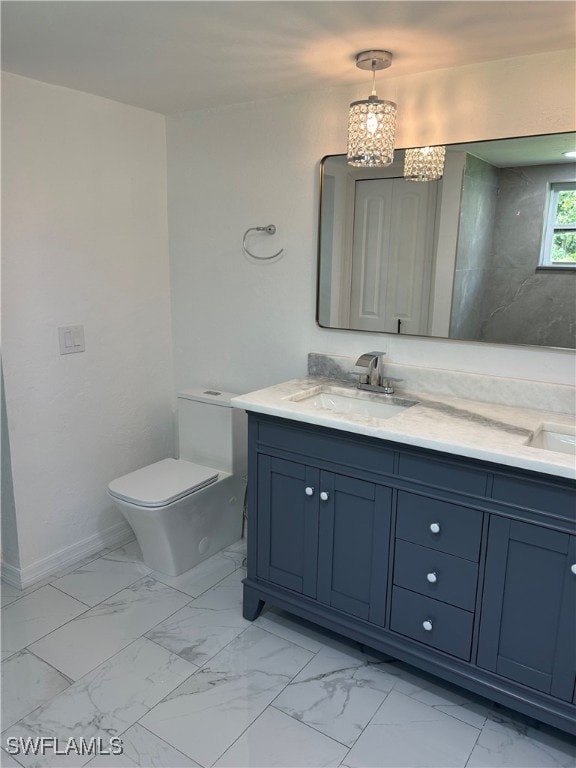 bathroom with tile patterned flooring, toilet, vanity, and a chandelier