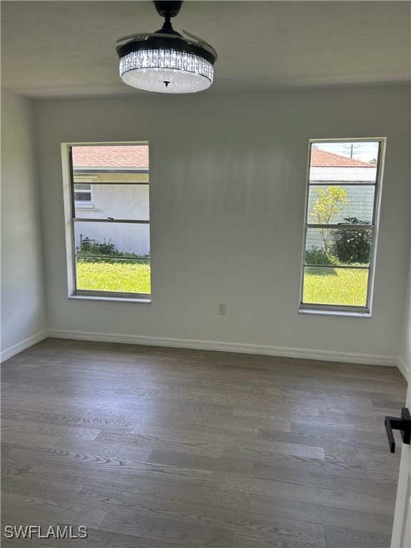 unfurnished room with hardwood / wood-style flooring