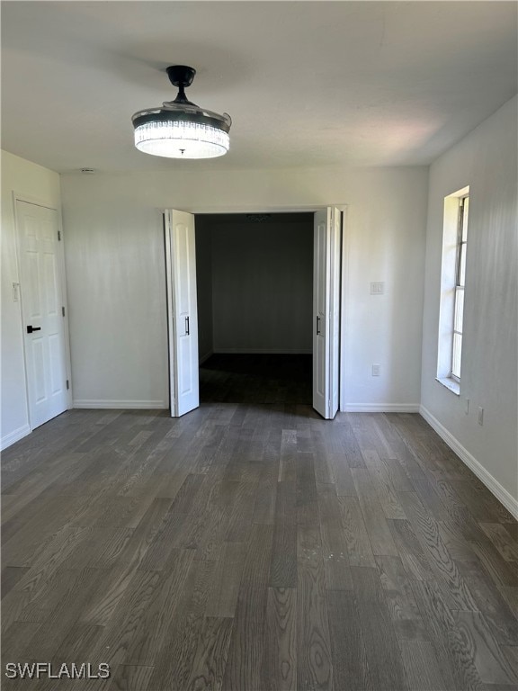 unfurnished room with dark hardwood / wood-style floors