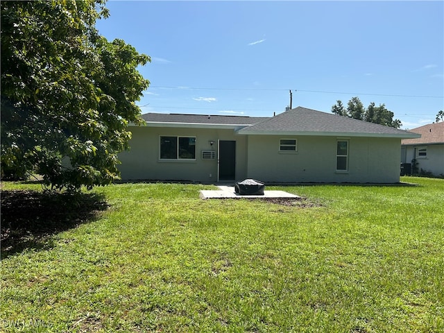 back of property with a patio area and a yard