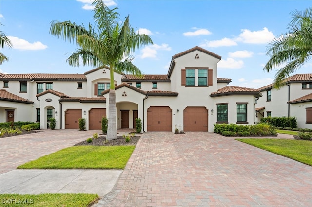 mediterranean / spanish house featuring a garage