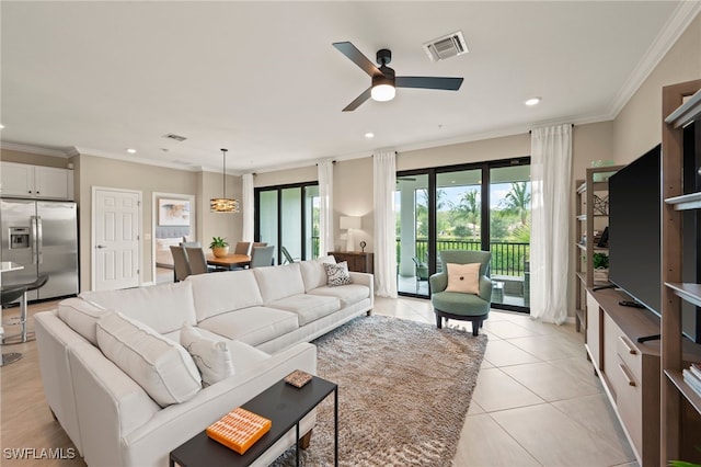 tiled living room with ceiling fan and ornamental molding