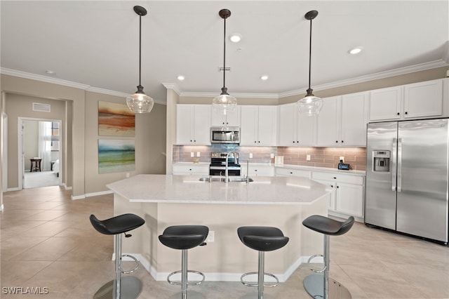 kitchen featuring stainless steel appliances, decorative backsplash, white cabinetry, sink, and hanging light fixtures