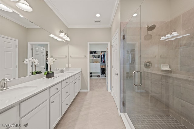 bathroom featuring tile patterned flooring, a shower with door, crown molding, and dual bowl vanity