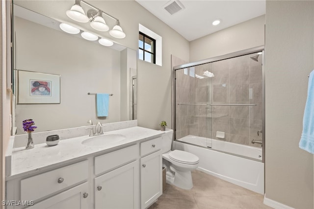 full bathroom featuring tile patterned flooring, combined bath / shower with glass door, toilet, and vanity