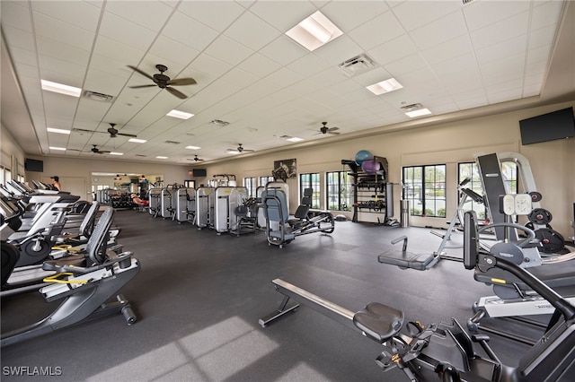 gym featuring ceiling fan and a paneled ceiling