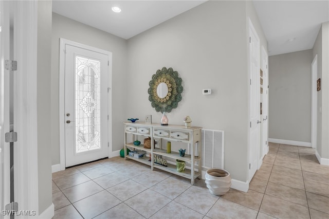 foyer entrance with plenty of natural light and light tile patterned floors