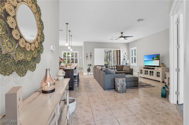 living room with ceiling fan and light tile patterned floors