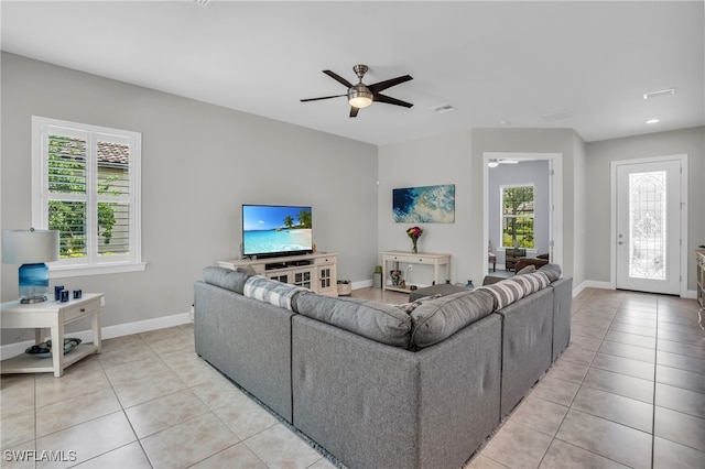 tiled living room with ceiling fan