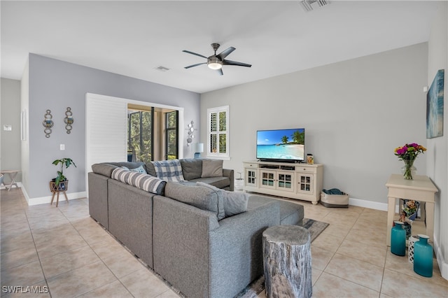 tiled living room featuring ceiling fan