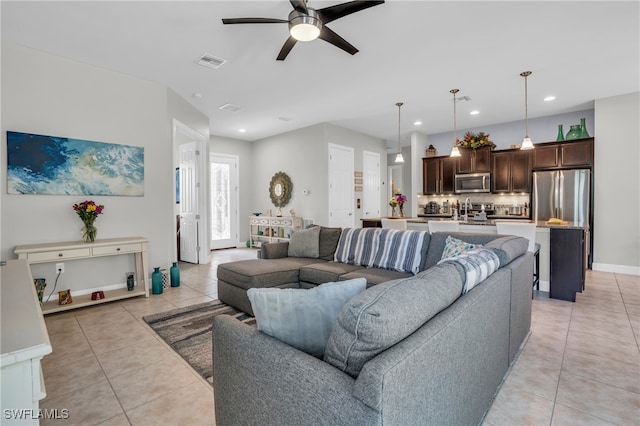 tiled living room featuring ceiling fan