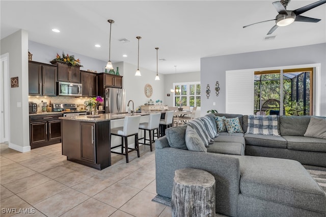 tiled living room featuring ceiling fan