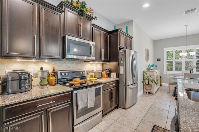 kitchen featuring appliances with stainless steel finishes, dark brown cabinets, and backsplash