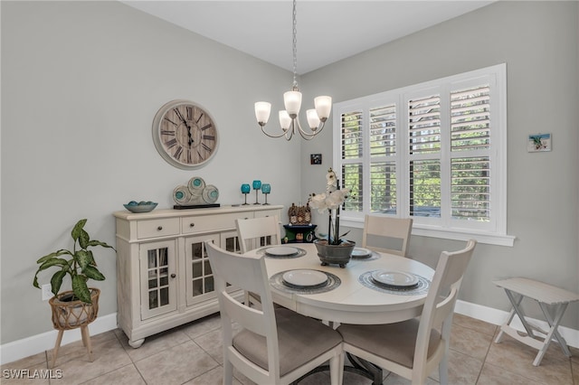 dining space featuring light tile patterned flooring and a chandelier