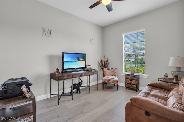 living room with light wood-type flooring and ceiling fan