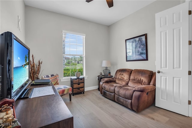 living room featuring ceiling fan and light hardwood / wood-style floors