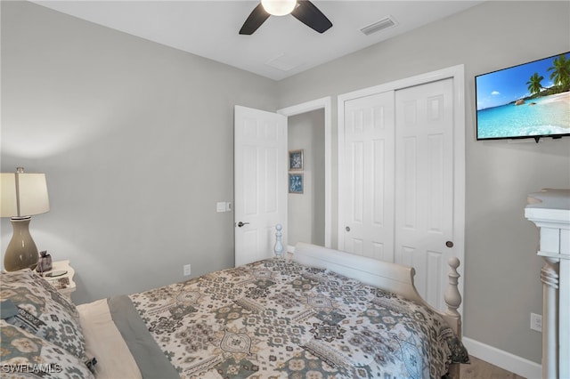 bedroom with ceiling fan, hardwood / wood-style flooring, and a closet