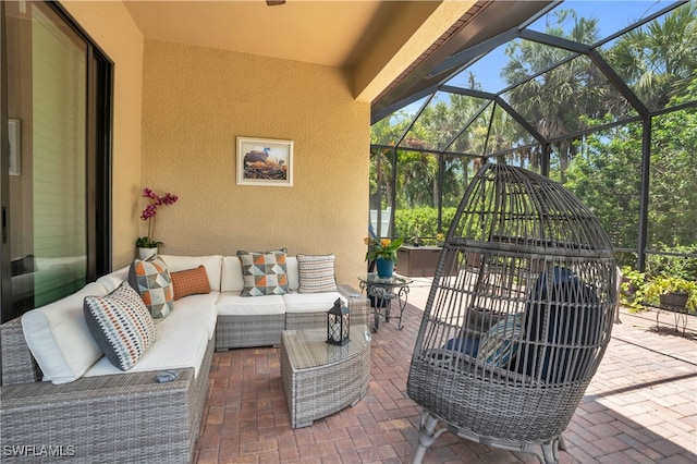 view of patio with an outdoor living space and glass enclosure