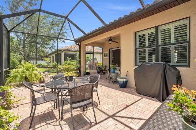 view of patio with ceiling fan, a grill, and a lanai