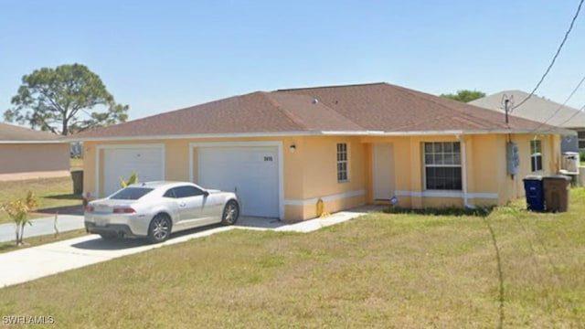 ranch-style house featuring a garage and a front yard