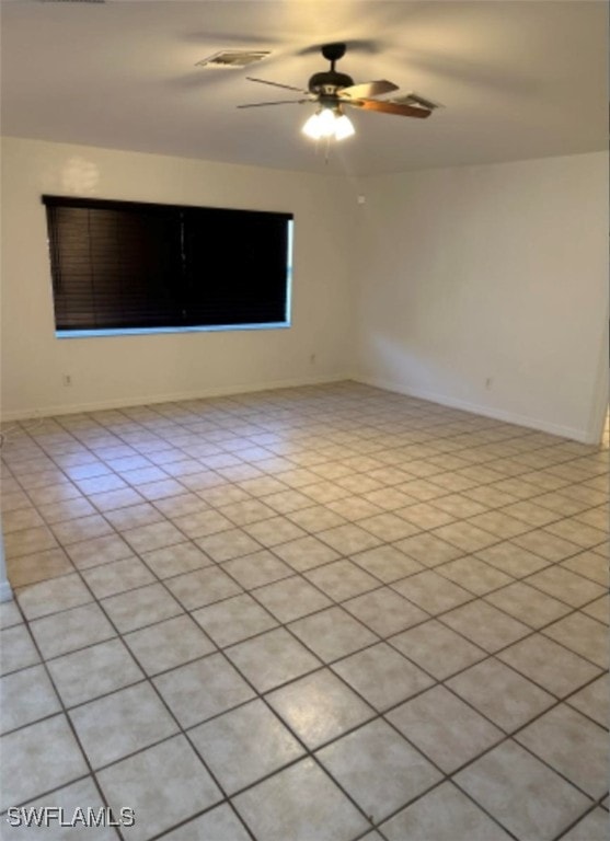 tiled empty room with ceiling fan