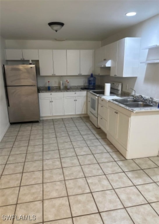 kitchen with white cabinetry, stainless steel refrigerator, sink, white electric stove, and light tile patterned floors