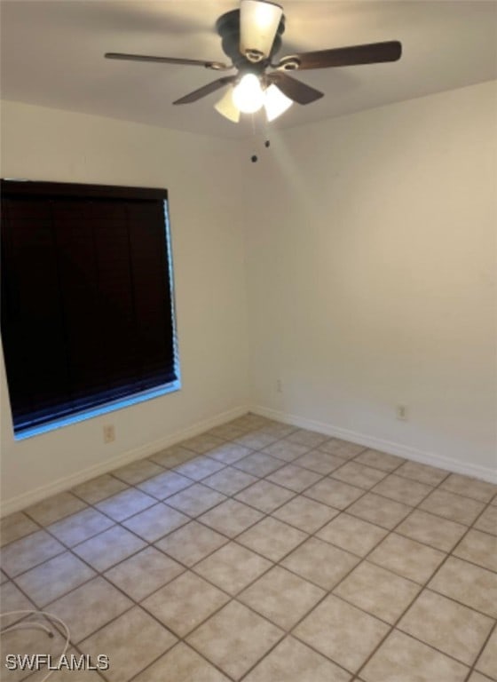 spare room with light tile patterned floors and ceiling fan