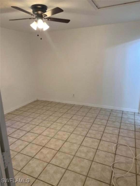 unfurnished room with ceiling fan and light tile patterned floors