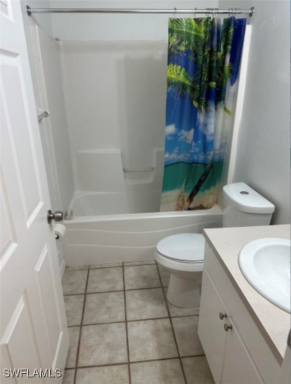 full bathroom with tile patterned floors, vanity, shower / tub combo with curtain, and toilet