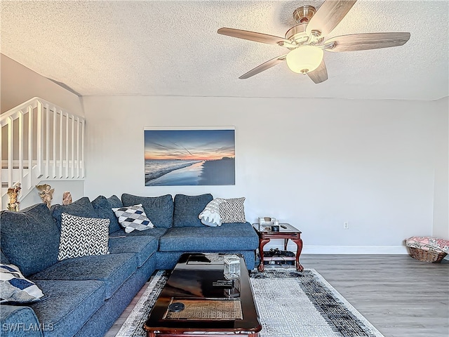 living room featuring a textured ceiling, ceiling fan, and hardwood / wood-style flooring