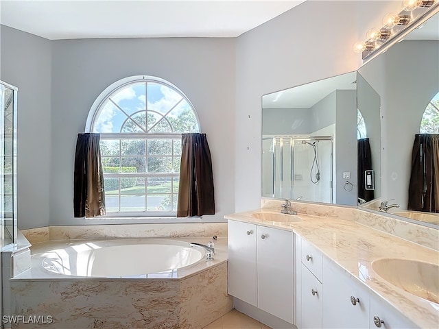 bathroom with a healthy amount of sunlight, separate shower and tub, and vanity