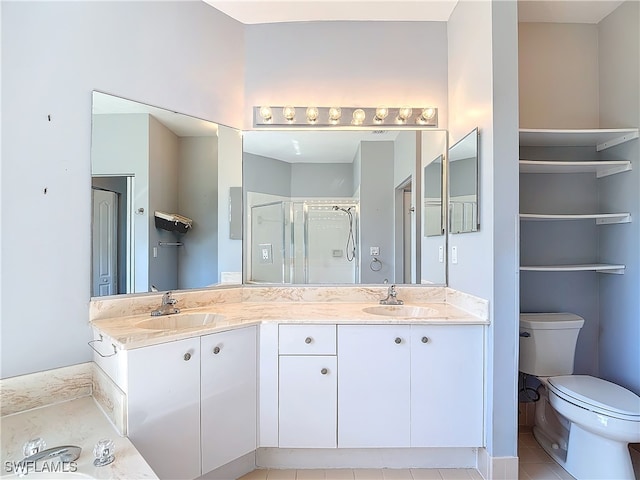 bathroom featuring vanity, toilet, tile patterned flooring, and a shower with door