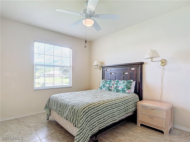 tiled bedroom with ceiling fan