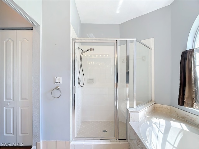 bathroom with shower with separate bathtub