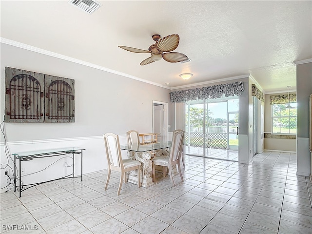 dining space with crown molding, a wealth of natural light, and ceiling fan