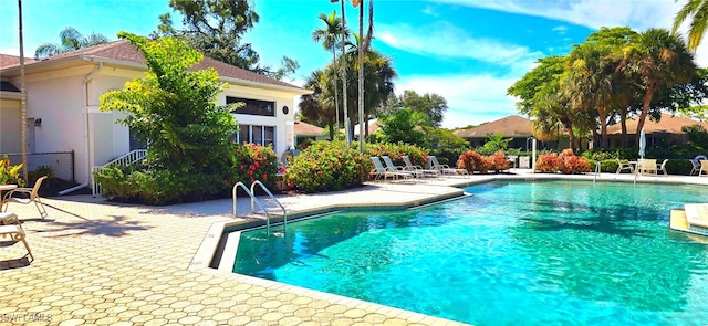 view of swimming pool with a patio area