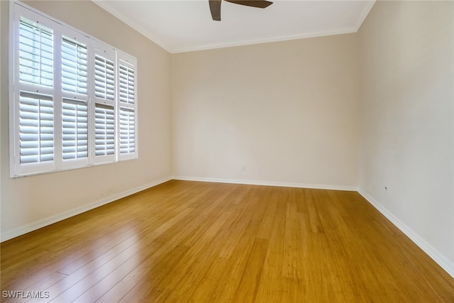 spare room featuring wood-type flooring, ornamental molding, and ceiling fan